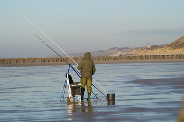 man sea fishing on the beach