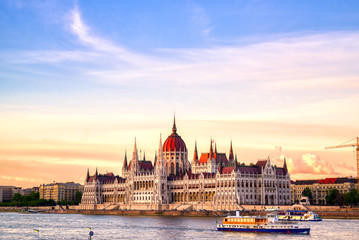 Naklejka premium The Hungarian Parliament Building located on the Danube River in Budapest Hungary at sunset.