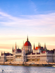 Obraz premium The Hungarian Parliament Building located on the Danube River in Budapest Hungary at sunset.