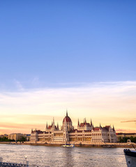 Naklejka premium The Hungarian Parliament Building located on the Danube River in Budapest Hungary at sunset.