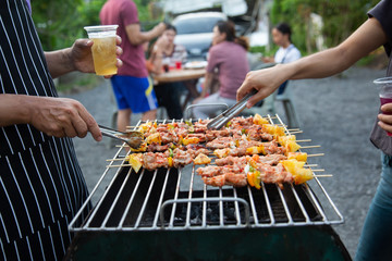 Barbeque Grill Street Food in thailand,Eat outdoors in a happy family. holiday celebration concept