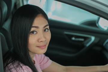 Asian girl smiling relaxing sitting and prepare drive safety