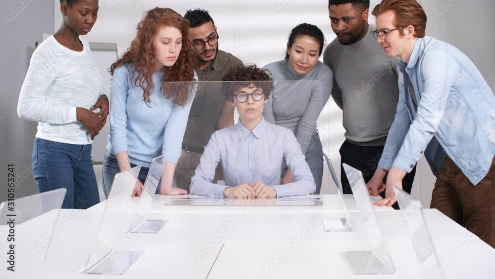 Poster medium shot of multinational students standing behind back of female teacher and watching while she 