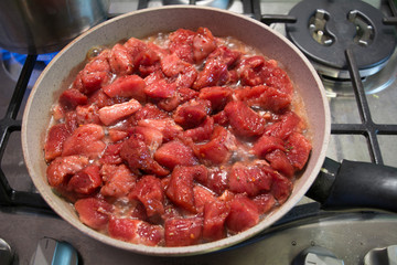 The meat in the pan. Cooking meat