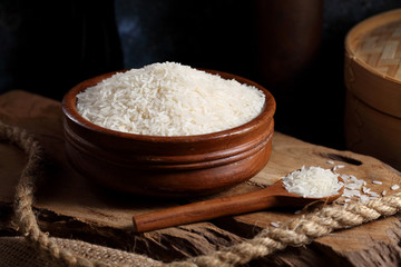 Close up white rice in measuring cup on table, Thai Jasmine rice in rustic kitchen background
