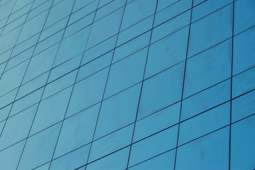 Fototapeta premium Blue glass windows of modern office building