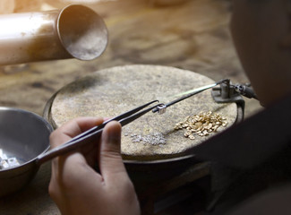 Goldsmith working jewelry process unfinished.