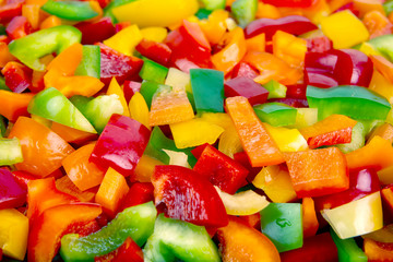 Sliced ​​colored bell peppers on a plate. Vitamin healthy food.