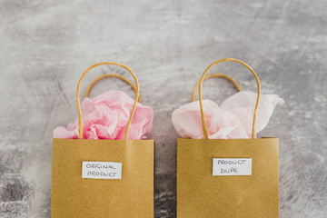 original product vs dupe imitation, shopping bags with labels side by side with similar paper color