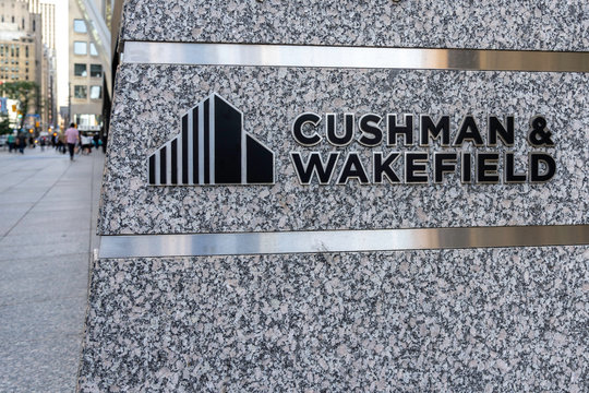 Sign of Cushman & Wakefield Canada at its head office with blurred city background in Toronto, Canada on August 13, 2019; an American commercial real estate services company.
