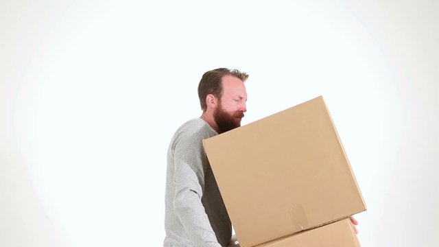Adult male lifting heavy boxes with severe back pain