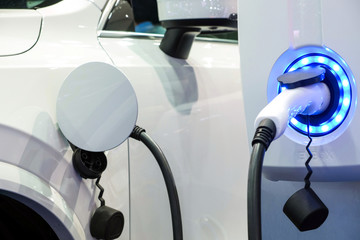 Close-up modern white  EV Car rechargeable energy form electric charge machine, Electric power is...