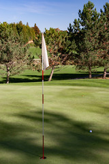 Obraz premium landscape fall foliage at Golf Course flag in hole at front