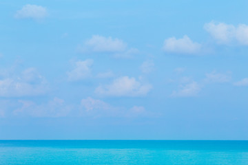 Floating clouds, fluffy colors against the blue sky and the sea