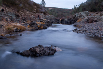 Consumnis river california granite rocks and rushing water.
