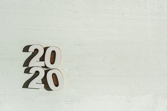 2020 text with wood cut on wooden floor on white background in happy new year 2020 concept