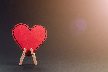 Red heart on the clothespin with the greeting happy Valentines day on dark background. - 310573874