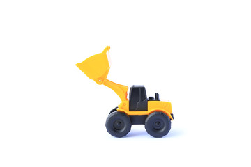 The yellow toy car Bulldozer isolated on white background. Children's tractor toy. Wheel loader construction car model.