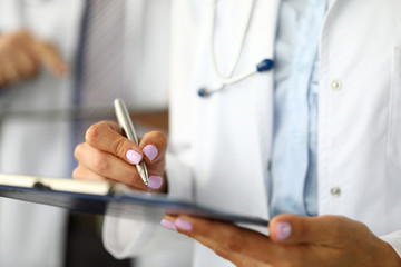 Arms of GP signing with silver pen important document