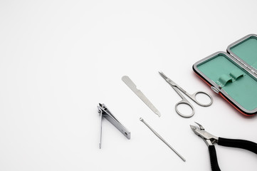 Set of manicure instruments and tools with the case isolated on white background. Scissors, Nail Cutter, Cuticle Pusher, Cuticle Nipper, Nail Buffer, Nail File, Nail Brush.