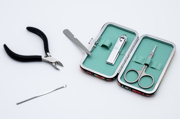 Set of manicure instruments and tools with the case isolated on white background. Scissors, Nail Cutter, Cuticle Pusher, Cuticle Nipper, Nail Buffer, Nail File, Nail Brush.
