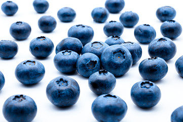 Fresh natural blueberries isolated on white background. Daily rate of vitamins in small purple berries.
