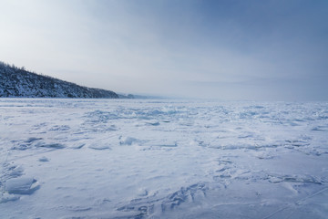 Fototapeta na wymiar winter landscape with frozen Baikal lake and blue sky
