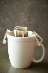 Hand drip coffee in white mug cup 