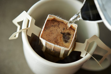 Hand drip coffee in white mug cup 