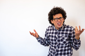 Fototapeta premium Latin American man looking confused, irritated, neutral background 