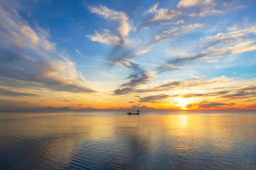 A small local fishing boat was sailing into the sea in the morning.