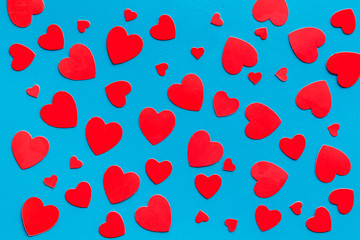 Red hearts pattern - Valentine's Day concept - on blue background top-down