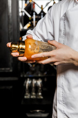 Bartender shaking a cocktail in a glass shaker