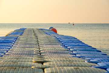 plastic pontoon on the sea going into the distance for swimming