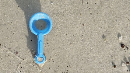 Image of kid's toy at a beach sand