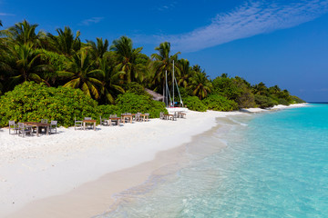 Secluded private beach with tables and chairs