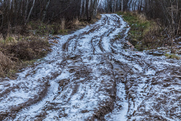 The bad ground or soil rural or suburb road or way with puddles, pools, mud and slush