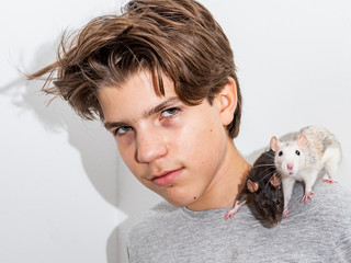 Young man carries his two pet rats on his shoulder