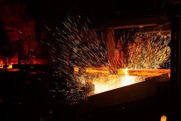 Hot red steel billets at torch cutting. Background of the blacksmith and metallurgical industry.