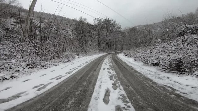 Driving on the country snowy road in winter