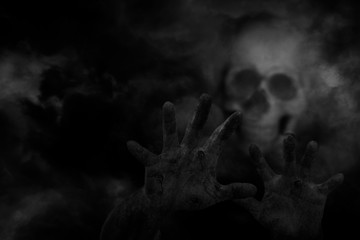 Ghost hand scary with cloud of smoke background, concept of horror and Halloween