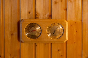 sauna thermometer and sauna hygrometer in sauna room .