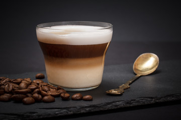 Coffee cappuccino and coffee beans on black background