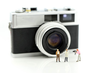 Miniature people : cameraman ,Videographer at work shooting on film camera.