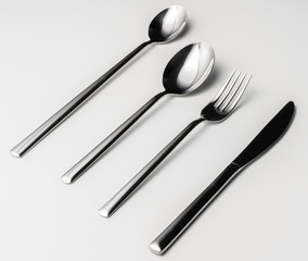 Spoon, fork and knife on a white background