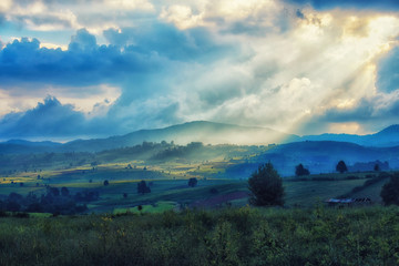 Cloudy day with sun ray effects on the farm, landscape photo