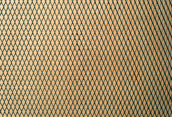 green mesh fence on pink concrete background