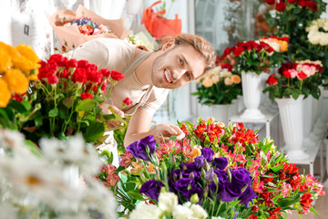 Florist making beautiful bouquet in shop