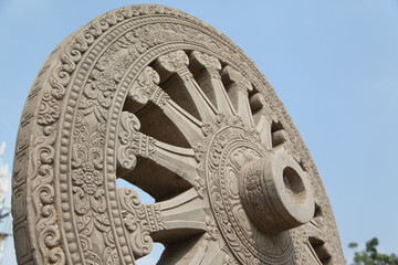 Wheel of Dhamma on blue sky background