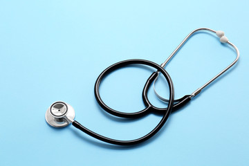 Stethoscope on color background. Cardiology concept